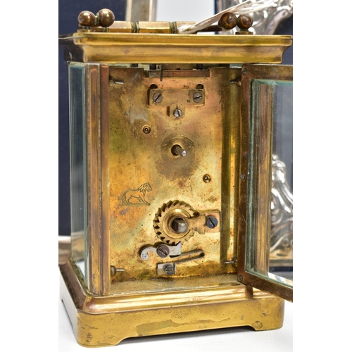 103 - TWO SILVER PHOTO FRAMES AND A CARRIAGE CLOCK, the first frame featuring a floral design and an oval ... 