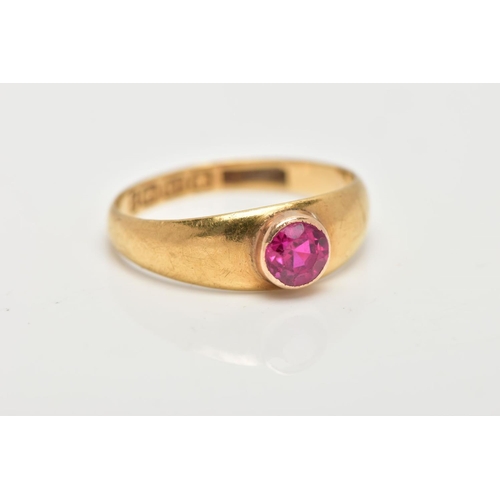 11 - AN 18CT GOLD RUBY RING, a circular cut ruby, bezel set, domed tapered band, approximate width 6mm to... 