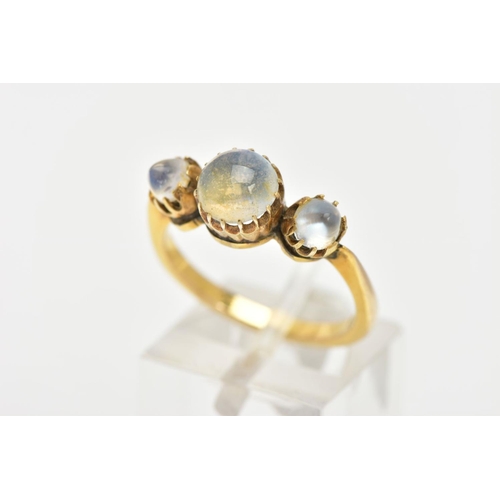 143 - A YELLOW METAL MOONSTONE RING, designed with a central circular cut moonstone and flanked with two d... 