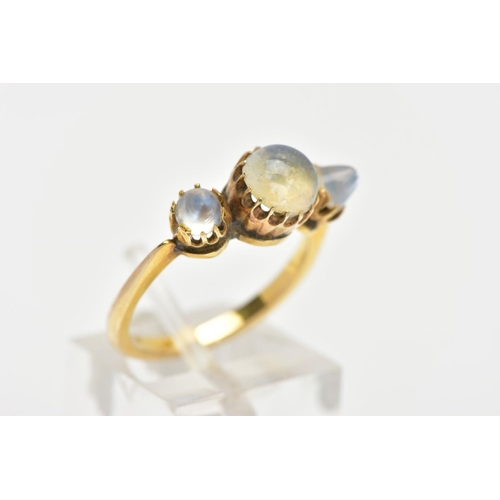 143 - A YELLOW METAL MOONSTONE RING, designed with a central circular cut moonstone and flanked with two d... 