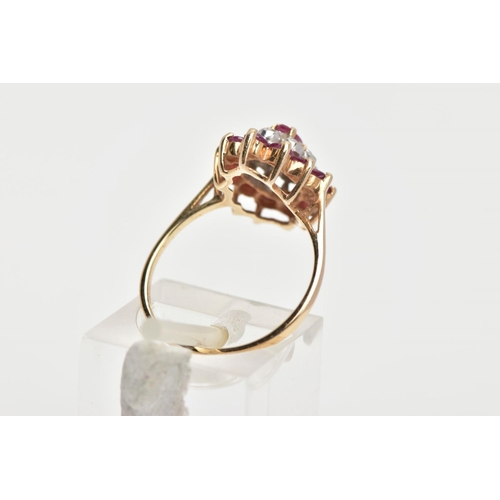 144 - A 9CT GOLD RUBY AND DIAMOND CLUSTER RING, slightly raised cluster of a navette shape, set with a cen... 