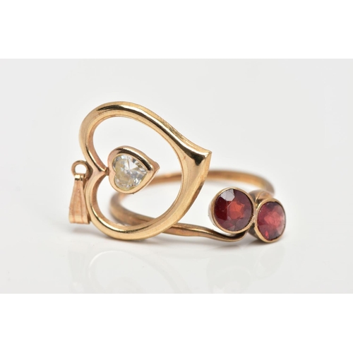 145 - A YELLOW METAL GARNET RING AND A PENDANT, the ring of a crossover design, set with two circular cut ... 