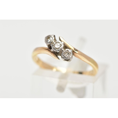 148 - A THREE STONE DIAMOND RING, three round brilliant cut diamonds in a white metal setting, with a yell... 