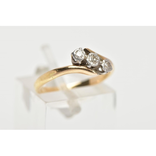 148 - A THREE STONE DIAMOND RING, three round brilliant cut diamonds in a white metal setting, with a yell... 