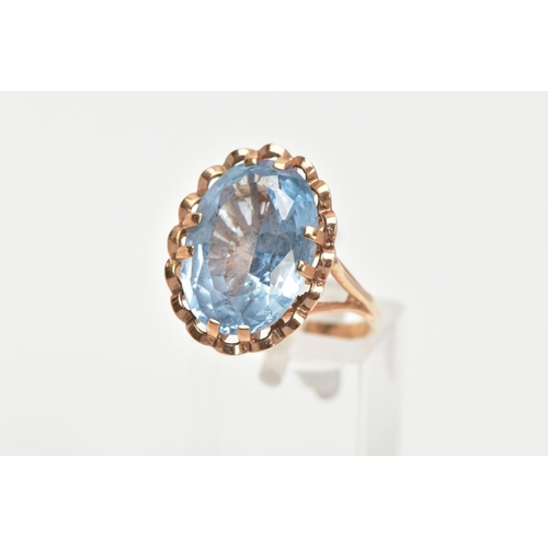 150 - A TOPAZ DRESS RING, a large oval cut blue stone assessed as topaz, approximate length 17mm, approxim... 