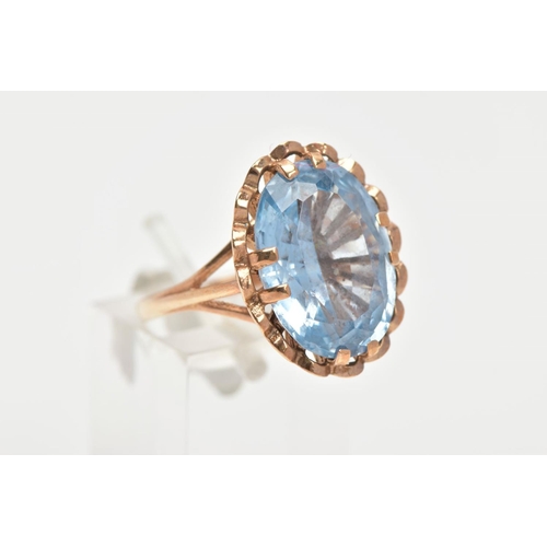 150 - A TOPAZ DRESS RING, a large oval cut blue stone assessed as topaz, approximate length 17mm, approxim... 