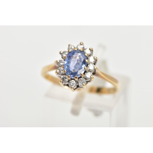 158 - A 9CT GOLD SAPPHIRE AND DIAMOND RING, oval cut sapphire set with a halo of round brilliant diamonds,... 