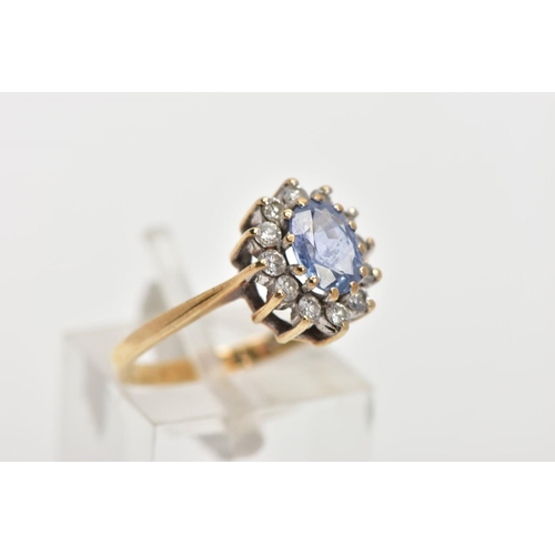 158 - A 9CT GOLD SAPPHIRE AND DIAMOND RING, oval cut sapphire set with a halo of round brilliant diamonds,... 