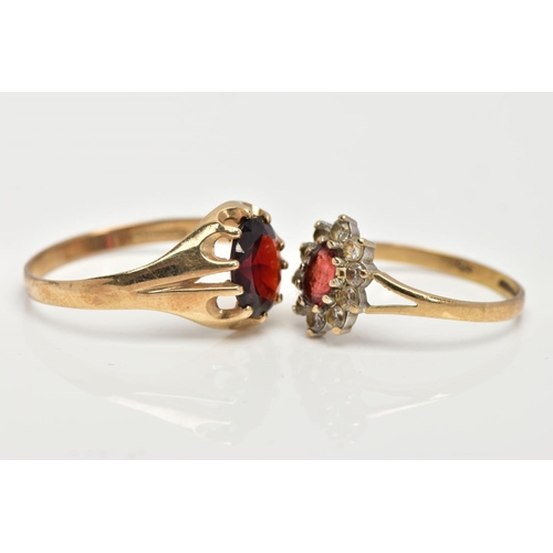 16 - TWO 9CT GOLD GARNET RINGS, the first of an oval design set with an oval cut garnet within a ten claw... 