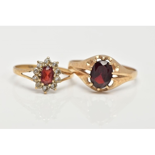 16 - TWO 9CT GOLD GARNET RINGS, the first of an oval design set with an oval cut garnet within a ten claw... 