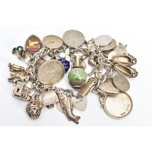 179 - A WHITE METAL CHARM BRACELET, WITH SILVER AND WHITE METAL CHARMS, a curb link chain fitted with a he... 