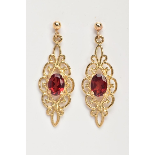 19 - A PAIR OF GARNET EARRINGS, a pair of yellow metal filigree designed drop earrings, set with an oval ... 