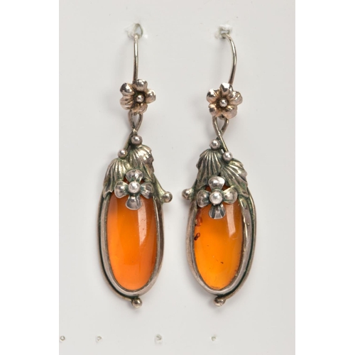 20 - A PAIR OF SILVER AND AMBER EARRINGS, elongated oval amber set into floral and foliage silver mounts,... 