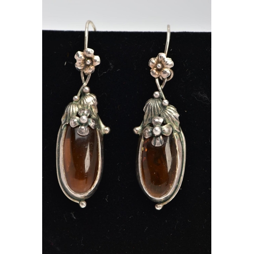 20 - A PAIR OF SILVER AND AMBER EARRINGS, elongated oval amber set into floral and foliage silver mounts,... 