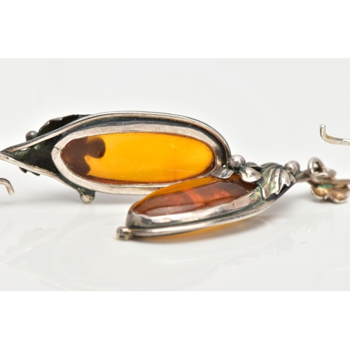 20 - A PAIR OF SILVER AND AMBER EARRINGS, elongated oval amber set into floral and foliage silver mounts,... 