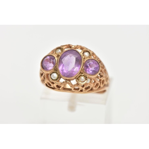 22 - AN AMETHYST AND SEED PEARL DRESS RING, three stone ring set with a central oval cut amethyst flanked... 