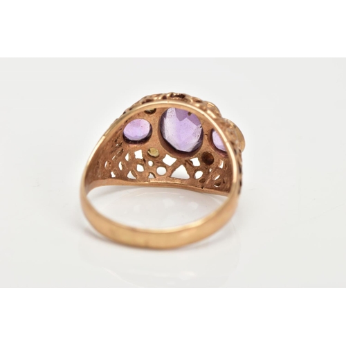 22 - AN AMETHYST AND SEED PEARL DRESS RING, three stone ring set with a central oval cut amethyst flanked... 