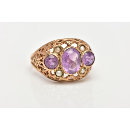 22 - AN AMETHYST AND SEED PEARL DRESS RING, three stone ring set with a central oval cut amethyst flanked... 