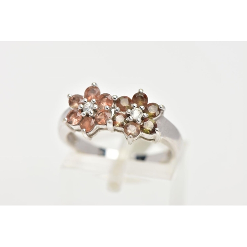 26 - A 9CT WHITE GOLD GEM SET CLUSTER RING, a double flower design set with twelve circular cut stones as... 