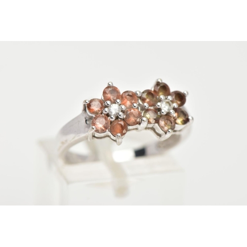 26 - A 9CT WHITE GOLD GEM SET CLUSTER RING, a double flower design set with twelve circular cut stones as... 