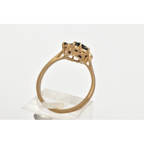 27 - A 9CT GOLD SAPPHIRE CLUSTER RING, seven circular cut sapphires prong set in a floral design, leading... 