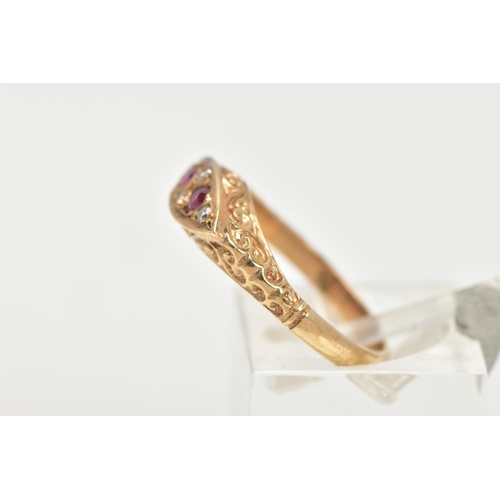 28 - A 9CT GOLD RUBY AND DIAMOND BOAT RING, a navette shaped ring set with two circular cut ruby stones, ... 