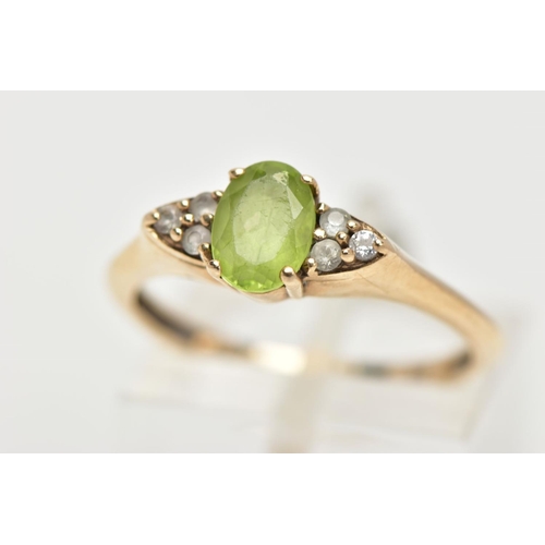 31 - A 9CT GOLD PERIDOT RING, an oval cut peridot, accented with six circular cut cubic zirconia, in a ye... 