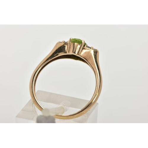 31 - A 9CT GOLD PERIDOT RING, an oval cut peridot, accented with six circular cut cubic zirconia, in a ye... 