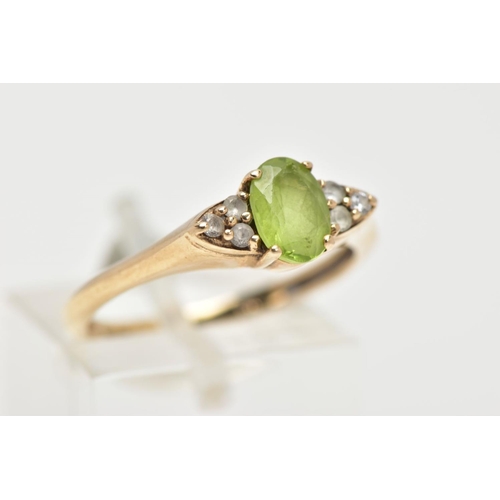 31 - A 9CT GOLD PERIDOT RING, an oval cut peridot, accented with six circular cut cubic zirconia, in a ye... 