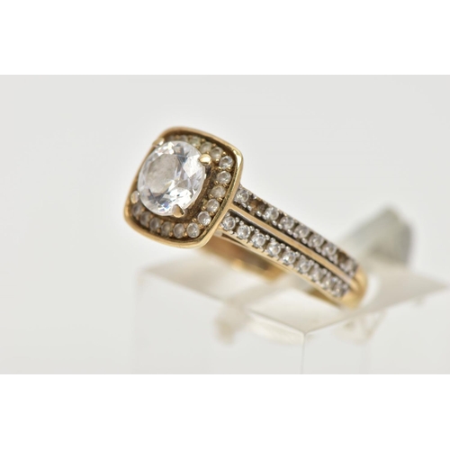 33 - A 9CT GOLD CUBIC ZIRCONIA RING,  a circular cut cubic zirconia, set within a squared halo of circula... 