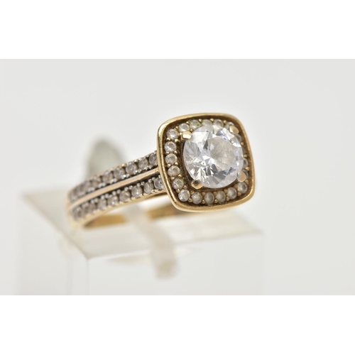 33 - A 9CT GOLD CUBIC ZIRCONIA RING,  a circular cut cubic zirconia, set within a squared halo of circula... 