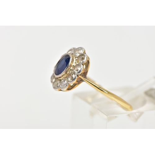 39 - A SAPPHIRE AND DIAMOND RING, an oval cut sapphire bezel set with ten round brilliant cut diamonds, a... 