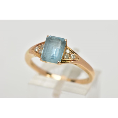 58 - A YELLOW METAL GEM SET RING, designed with a central rectangular cut aquamarine in a four claw setti... 