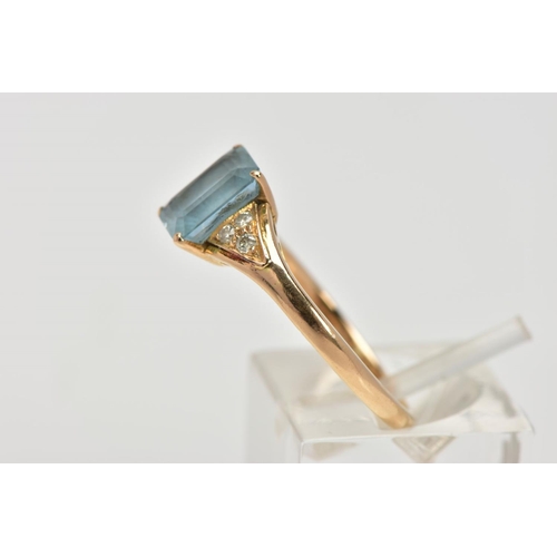 58 - A YELLOW METAL GEM SET RING, designed with a central rectangular cut aquamarine in a four claw setti... 