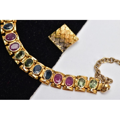 64 - A YELLOW METAL MULTI GEM SET LINE BRACELET, designed with square links each set with alternating ova... 