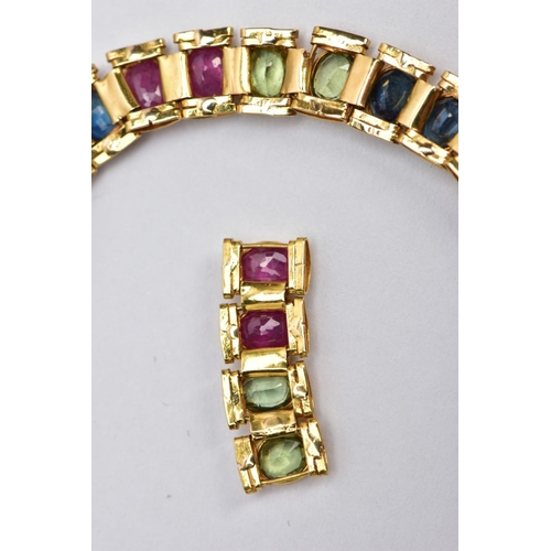 64 - A YELLOW METAL MULTI GEM SET LINE BRACELET, designed with square links each set with alternating ova... 