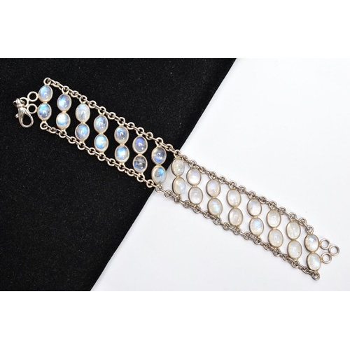 66 - A WHITE METAL MOONSTONE BRACELET, designed with two rows of oval cabochon moonstones each collet mou... 