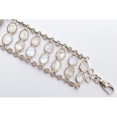 66 - A WHITE METAL MOONSTONE BRACELET, designed with two rows of oval cabochon moonstones each collet mou... 