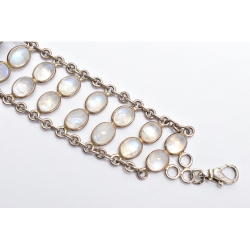 66 - A WHITE METAL MOONSTONE BRACELET, designed with two rows of oval cabochon moonstones each collet mou... 