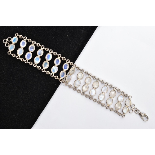 66 - A WHITE METAL MOONSTONE BRACELET, designed with two rows of oval cabochon moonstones each collet mou... 