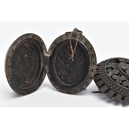 71 - A JET BROOCH AND A VULCANITE PENDANT, the jet brooch of a circular form, decorated with carved shamr... 