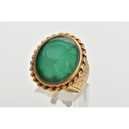 72 - A GENTS 9CT GOLD INTAGLIO RING, of an oval form, engraved soldiers head within a green chalcedony, c... 