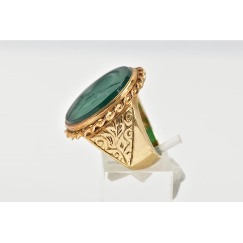 72 - A GENTS 9CT GOLD INTAGLIO RING, of an oval form, engraved soldiers head within a green chalcedony, c... 