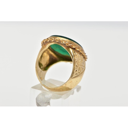 72 - A GENTS 9CT GOLD INTAGLIO RING, of an oval form, engraved soldiers head within a green chalcedony, c... 