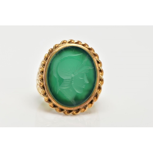 72 - A GENTS 9CT GOLD INTAGLIO RING, of an oval form, engraved soldiers head within a green chalcedony, c... 