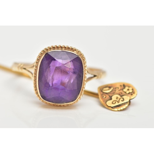 73 - A 9CT GOLD AMETHYST RING AND A STICK PIN, the ring designed with a cushion cut amethyst, collet moun... 