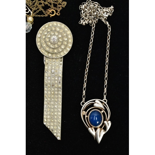 89 - AN 'OLA M GORIE' PENDANT AND CHAIN, a white metal open work heart pendant set with a blue oval caboc... 