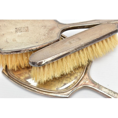 97 - THREE SILVER VANITY PIECES, comprising of a mirror, hair brush and clothes brush, each with an engin... 