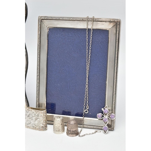 99 - TWO SILVER PHOTO FRAMES AND AN ASSORTMENT OF SILVER AND WHITE METAL JEWELLERY, the first frame featu... 