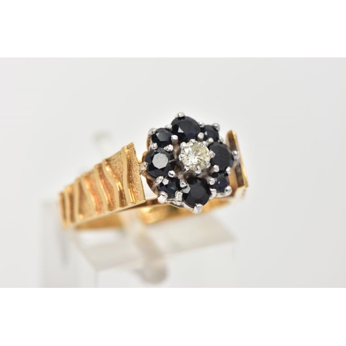 11 - A YELLOW METAL SAPPHIRE AND DIAMOND CLUSTER RING, a single round brilliant cut diamond set within a ... 